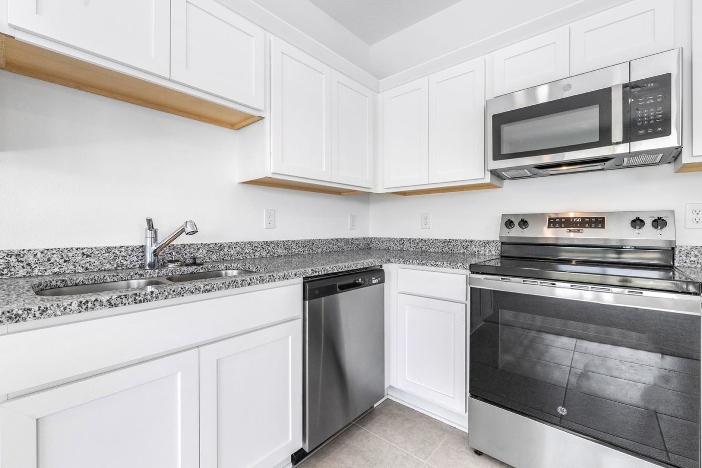 Kitchen detail: stainless range, microwave and granite