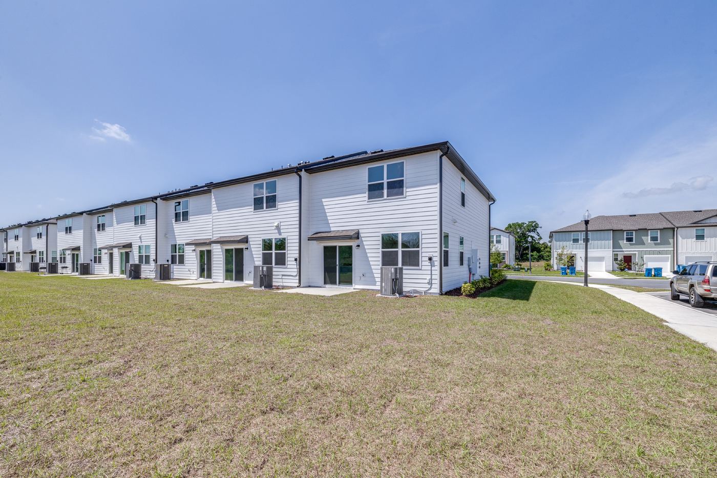 Rear elevation of the townhome building and open lawn